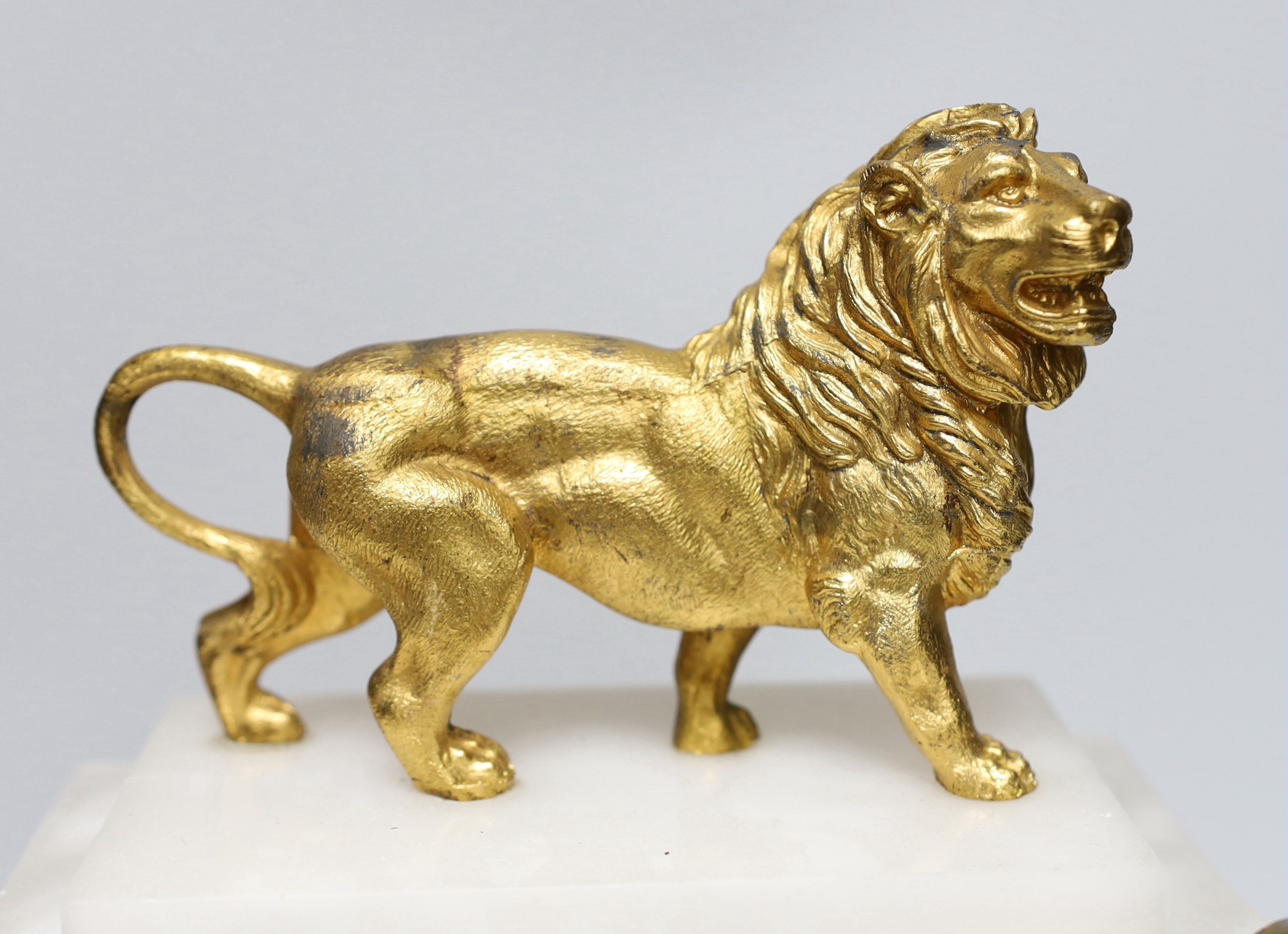 A French alabaster and gilt metal lion and ceramic mounted mantel clock, 34cm high